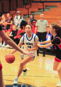 Senior, Cameron Thorton driving through the lane for a layup.